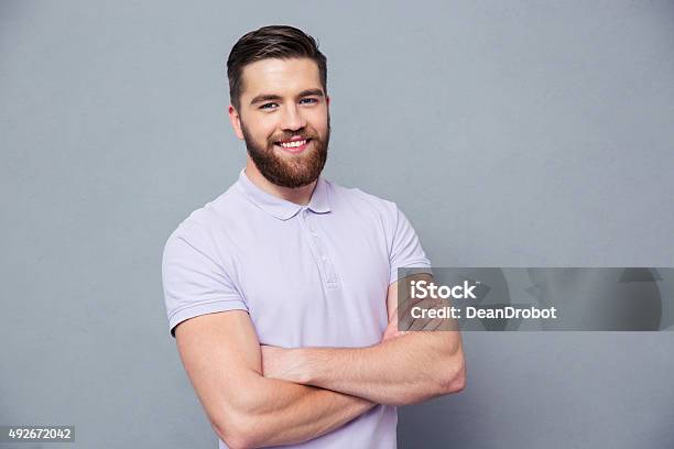 Happy Man Standing With Arms Folded Stock Photo - Download Image Now - 2015, Adult, Backgrounds