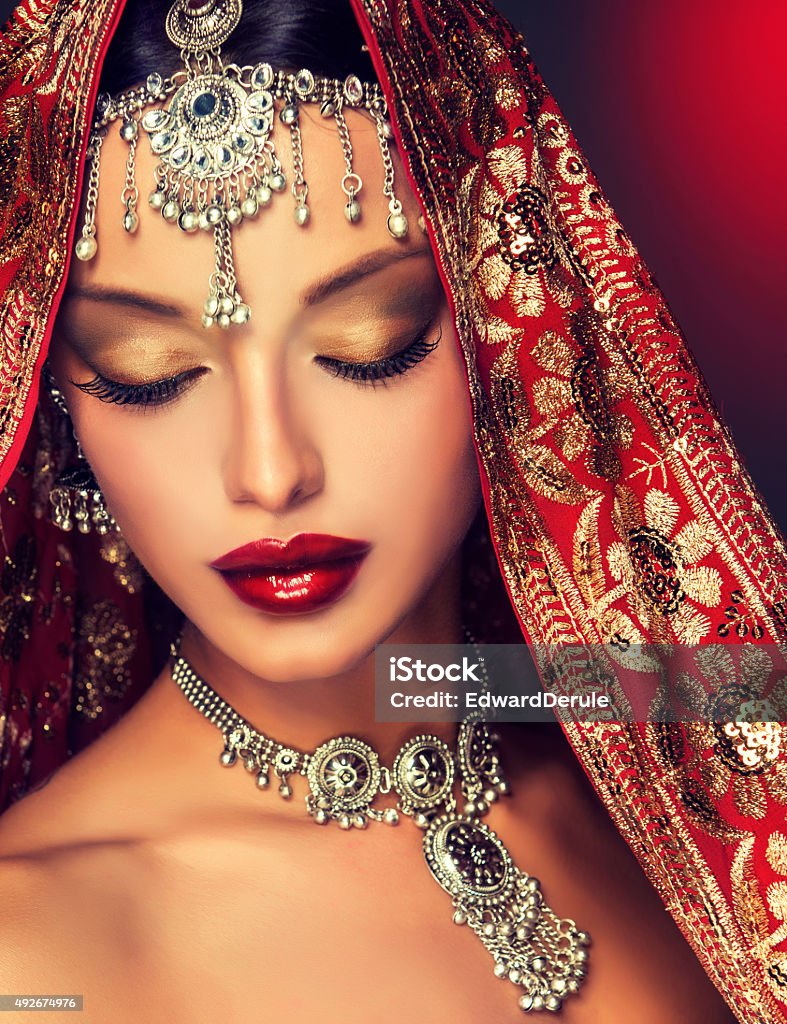 Beautiful Indian women portrait. Beautiful Indian women portrait with jewelry  and  red traditional saree Culture of India Stock Photo