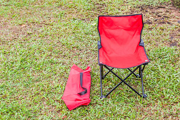 istock Foldable camping chair with the green lawn background. 492676020