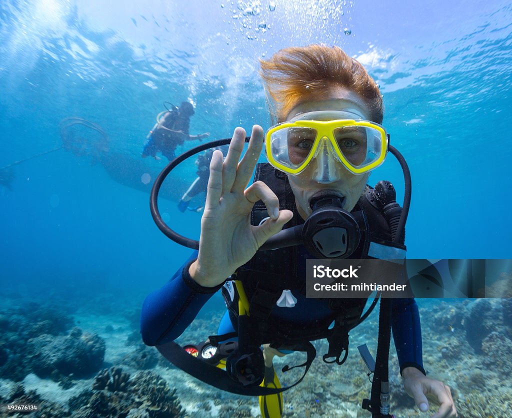 Diver Female scuba diver underwater showing ok signal Underwater Diving Stock Photo