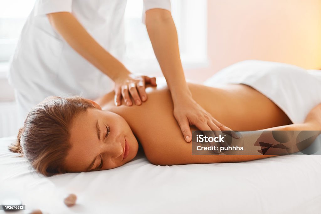 Spa Treatment. Woman enjoying Massage in Spa centre. Spa treatment. Woman enjoying relaxing back massage in cosmetology spa centre. Body care, skin care, wellness, wellbeing, beauty treatment concept. Massaging Stock Photo