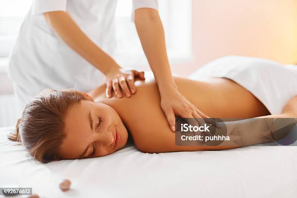 Spa Treatment Woman Enjoying Massage In Spa Centre Stock Photo - Download Image Now