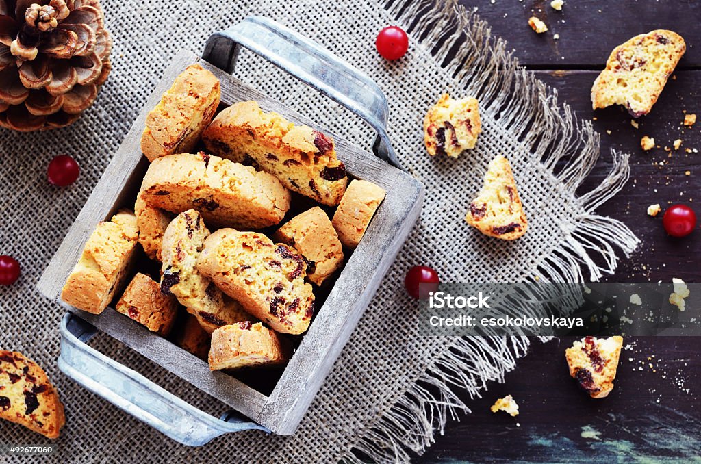 Cranberry biscotti in wooden box Cranberry biscotti in decorative crate on linen napkin on rusted wooden table Biscotti Stock Photo