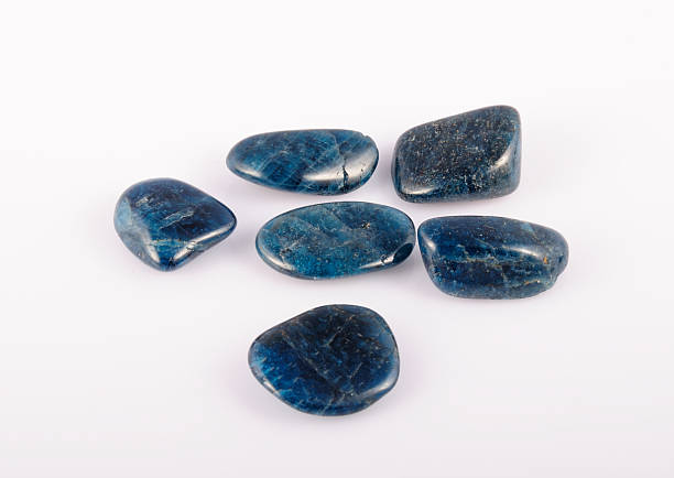istock deep blue Apatite gemstone on white. photo toned 492677804