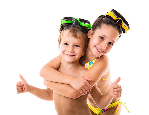 Two happy kids in diving masks Two happy kids in diving masks standing together, isolated on white scuba diving family stock pictures, royalty-free photos & images