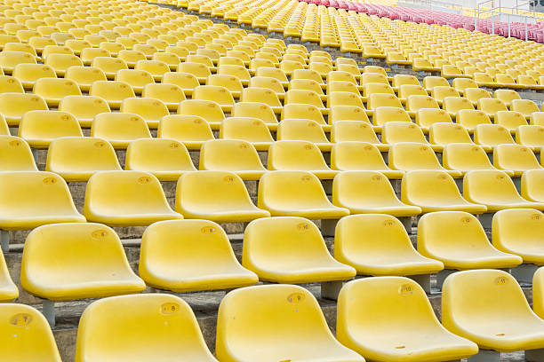 istock Field of empty yellow plastic stadium seats. 492681343