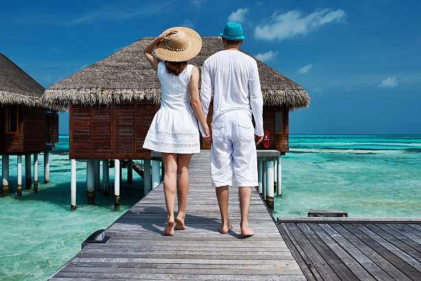 istock Couple on a beach jetty at Maldives 492682873