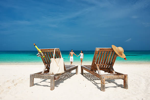 istock Couple in white running on a beach at Maldives 492683851