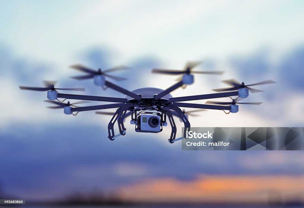 drone white cloudy dusk sky a drone flying in a cloudy sky where the sun goes down Drone Stock Photo