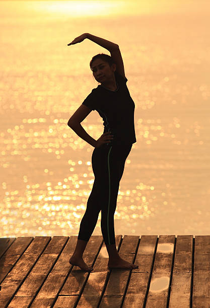 istock Yoga woman in serene sunset . 492684189