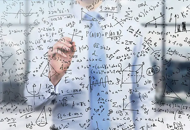 Photo of Quantitative analyst is drawing different math formulas on glass screen