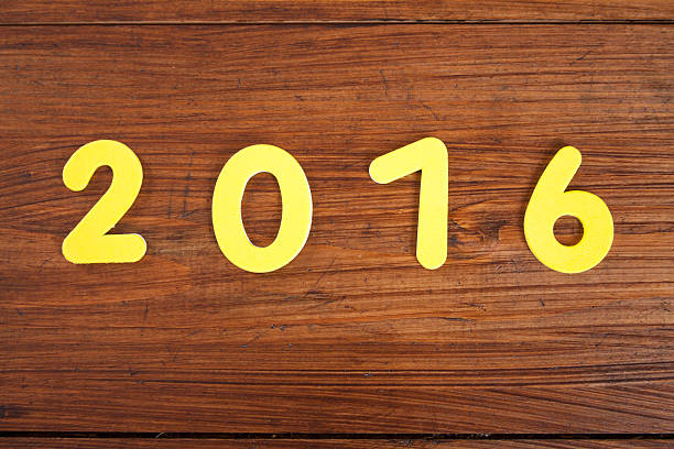 istock Year 2016, yellow, on wood, copy space 492694758