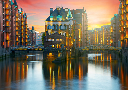 Old Speicherstadt in Hamburg illuminated at night. Sunset background