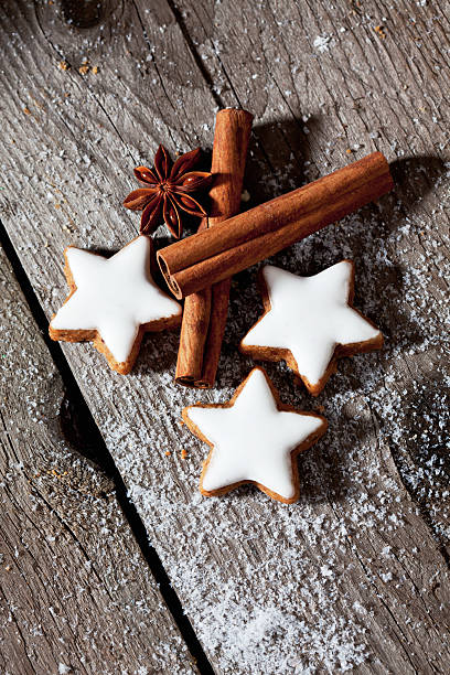 Cinnamon stars with spices on wooden background