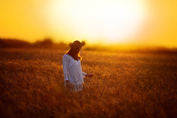 istock Woman in a wheat field at sunset 492697240