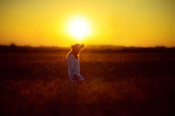 istock Woman in a wheat field at sunset 492697258