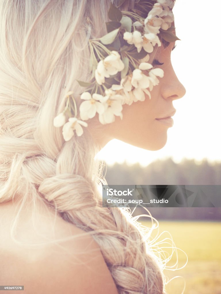 Romantic lady in wreath of apple trees Portrait of beautiful romantic lady in a wreath of apple trees in the summer garden Women Stock Photo