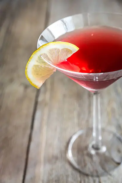 Cosmopolitan cocktail on the wooden background