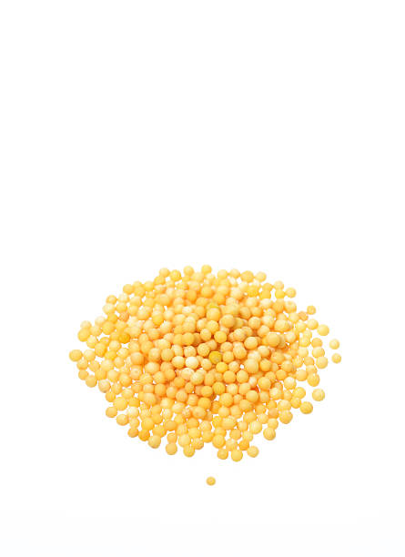 istock Yellow mustard seeds isolated on white background 492701016