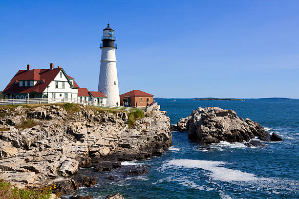 istock Portland Head Light, rocks, ocean surf, in morning. Blue sky. 492701278