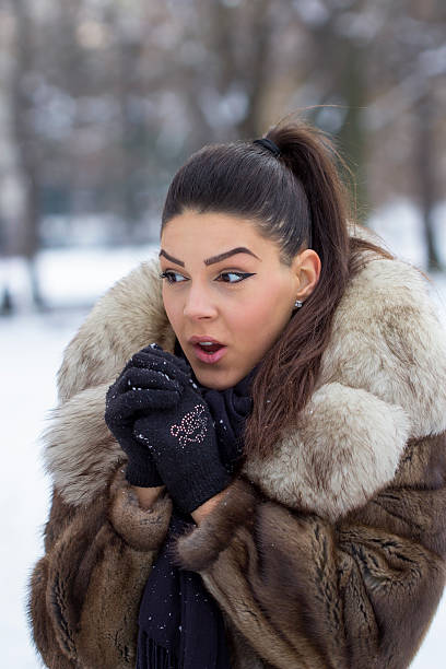istock Beautiful woman blowing in hads 492702038