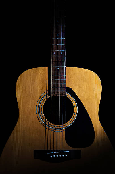 istock Acoustic guitar on black background. Close-up 492703098