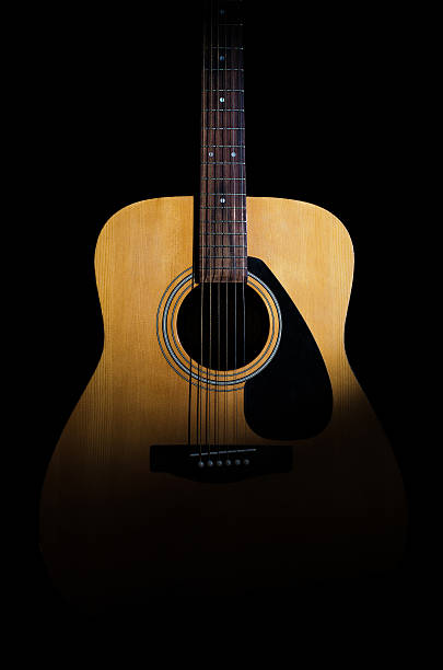 istock Acoustic guitar on a black background. Close-up 492703192