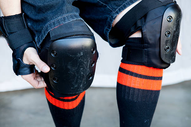 close-up knee pads a man wears knee pads ready for skating kneepad stock pictures, royalty-free photos & images