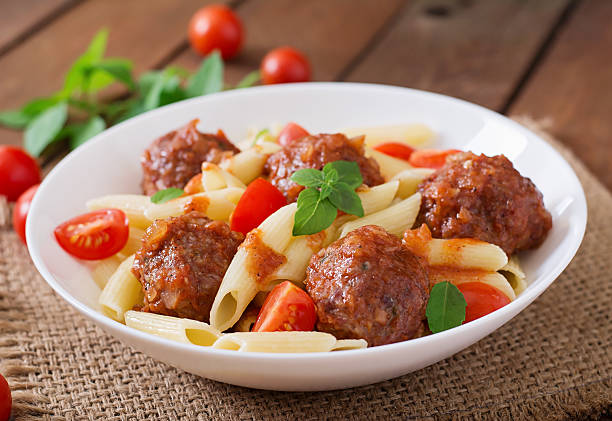 istock Penne pasta with meatballs in tomato sauce 492704844