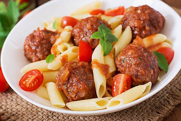 istock Penne pasta with meatballs in tomato sauce 492704996