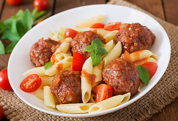 istock Penne pasta with meatballs in tomato sauce 492705052
