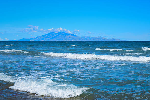 istock Seascape with waves and mountain on the background 492705796