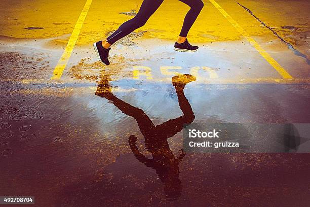 Young Person Running Over The Parking Lot Stock Photo - Download Image Now - Running, Track Event, Abstract