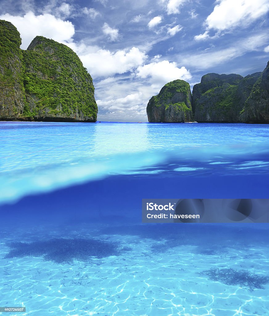 Beautiful lagoon with white sand bottom underwater view Beautiful lagoon at  Phi Phi Ley island with white sand bottom underwater and above water split view Water Stock Photo