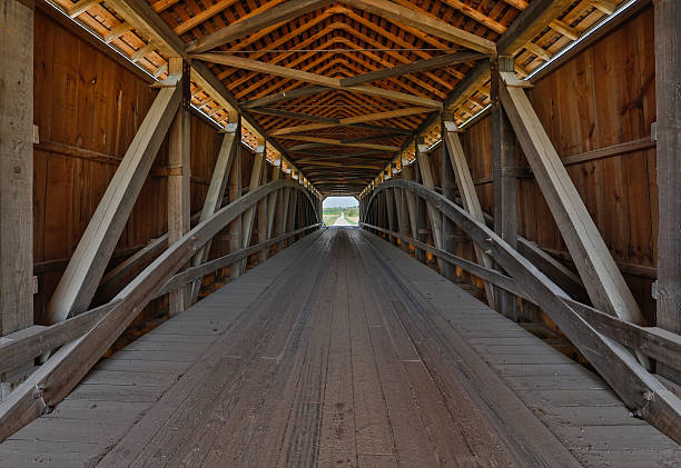 Covered Bridge Interior The wooden supporting architecture of covered bridge is viewed from the inside. This is Parke County, Indiana's Sanitorium Covered Bridge. indiana covered bridge stock pictures, royalty-free photos & images