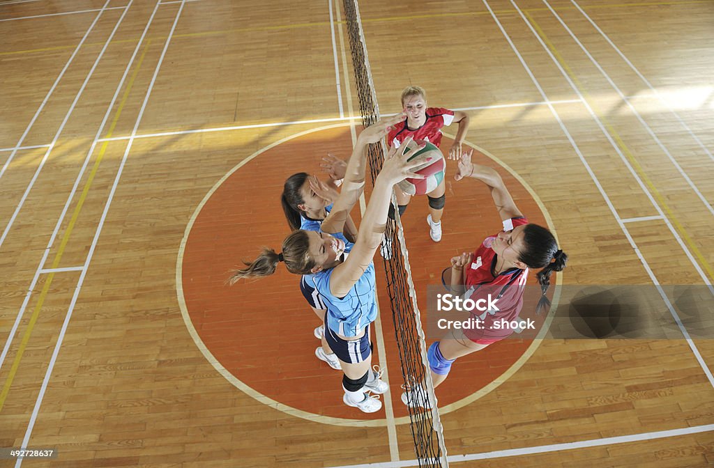 girls playing volleyball indoor game volleyball game sport with group of young beautiful  girls indoor in sport arena Activity Stock Photo