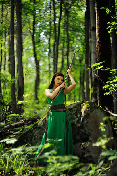 Estilizada Joven Mujer En Vestido Verde Con Palo Recto Foto de stock y más banco de imágenes de 2015 - iStock Estilizada Joven Mujer En Vestido Verde Con Palo Recto Foto de stock y más banco de imágenes de 2015 - iStock