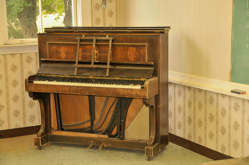 A old Piano in a old school class room.