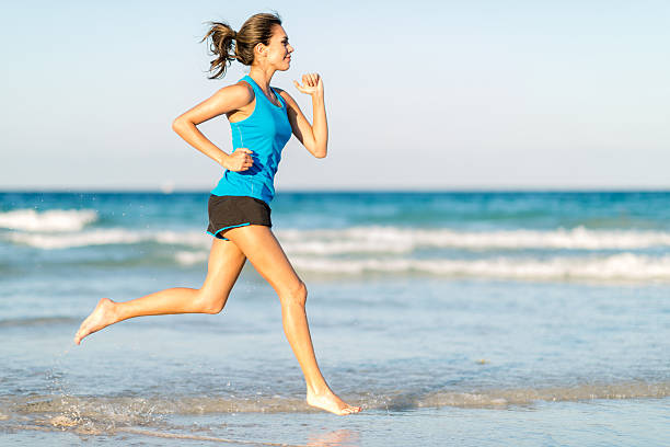 istock Woman running at the beach 492731997