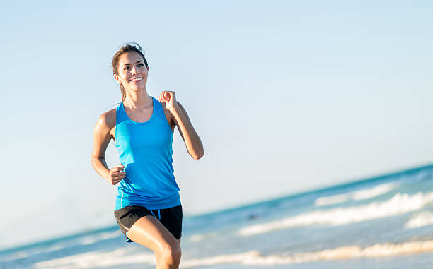 istock Woman running at the beach 492732051