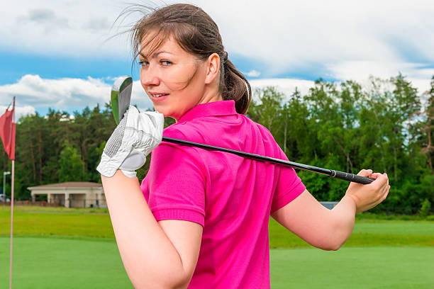 istock girl with a golf a club turned back 492732166