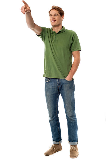 istock Casual young man pointing at something 492733267