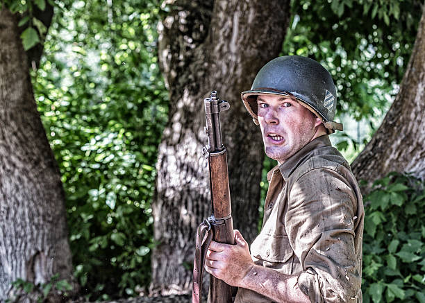 Old military helmet and rifle on a wooden background
