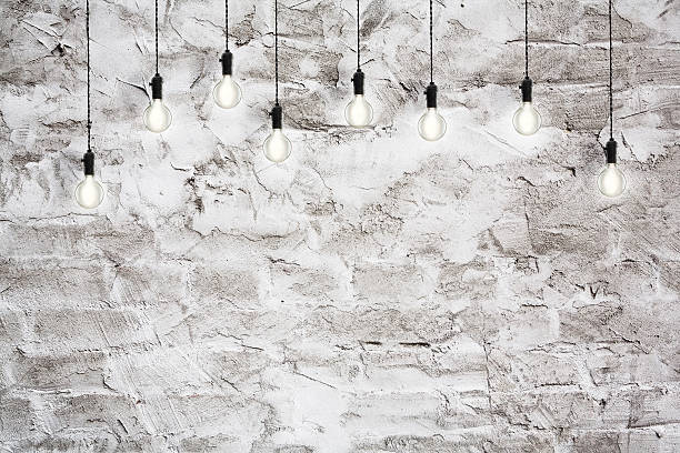 istock Idea concept - Vintage incandescent bulbs on wall background 492735250