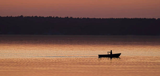 istock Woman rowing boat over lake at dusk 492736394