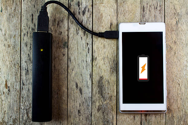 istock smart phone is charging with power bank 492737738