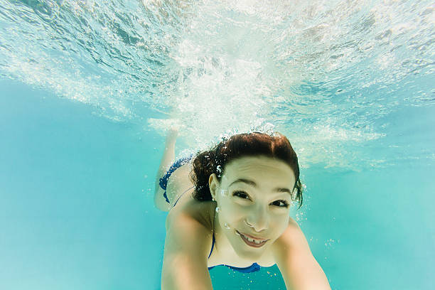 istock Smiling 8-Year-Old Girl Diving Underwater 492739004