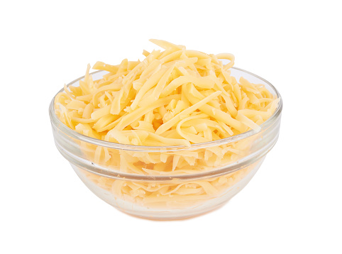 Glass bowl of grated cheese isolated on white