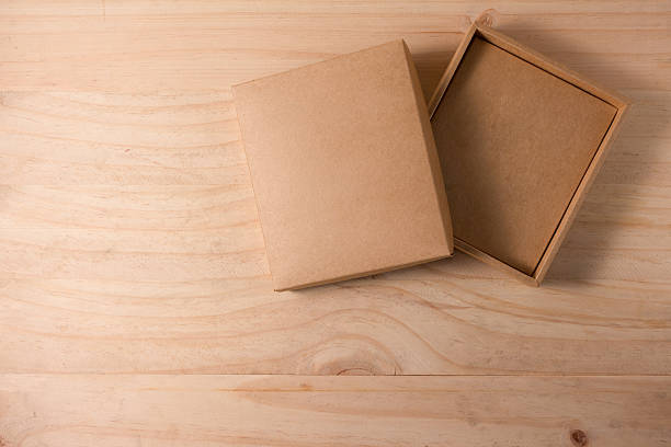 istock Opened cardboard box on wooden background 492740642