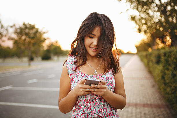 istock Young asian woman with mobile phone 492741206